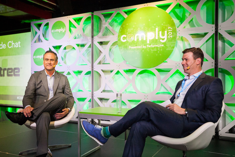 Doug Lebda and Alex Baydin sit down for a chat at COMPLY Conference with green backdrop